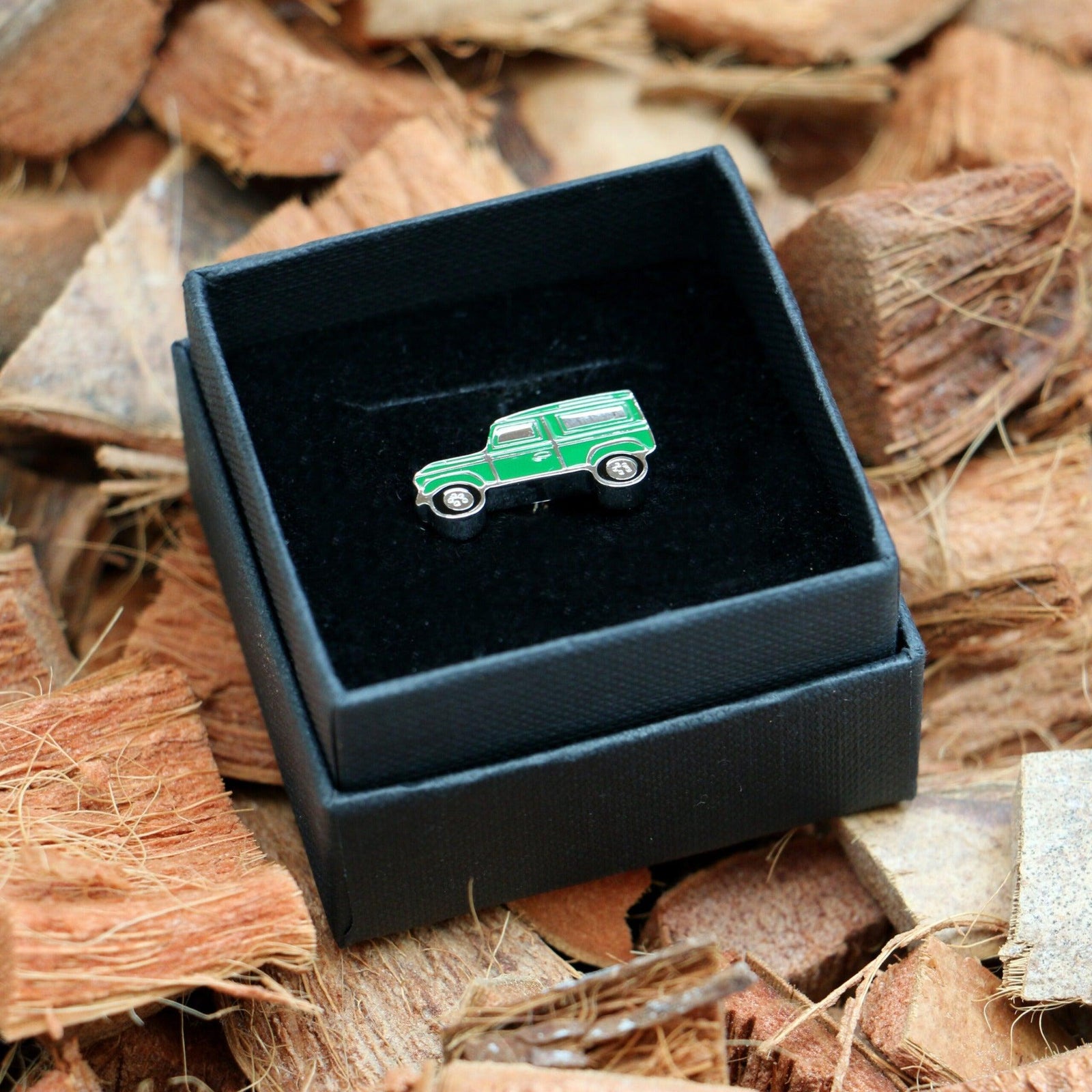 Green Land Rover style lapel pin badge presented in black gift box