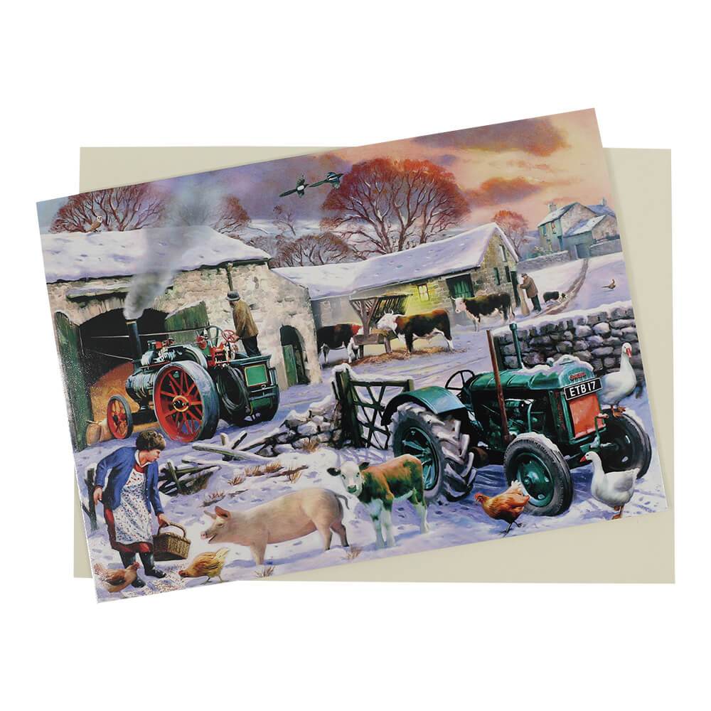This scenic traditional style Fordson tractor Christmas card features a green Fordson Model N in a snow-covered farmyard surrounded by farm animals and a vintage steam engine in the background.